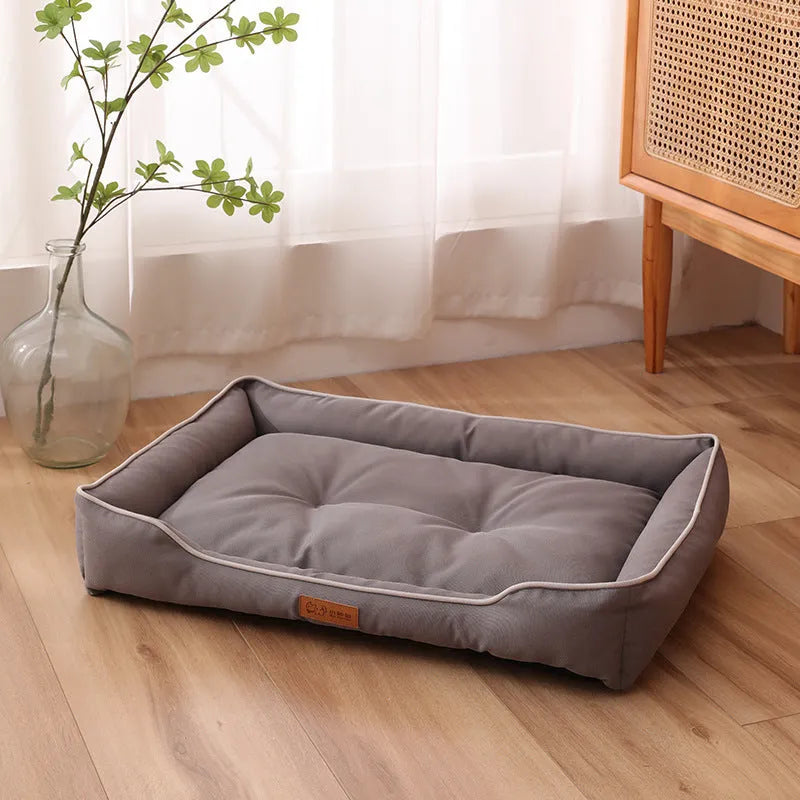 Grey waterproof Oxford cloth dog sofa bed on a wooden floor