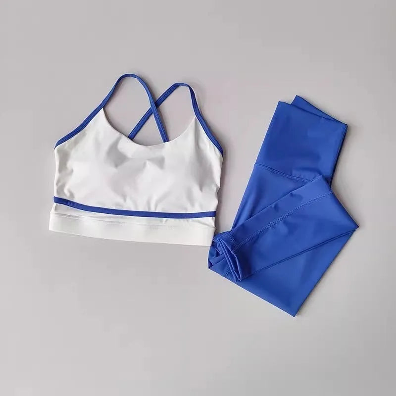 Women's blue and white nylon spandex yoga set with sleeveless tank top and cropped pants.