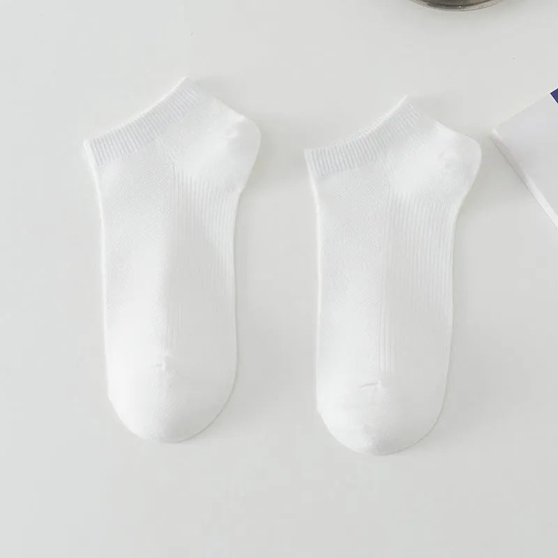 Pair of solid colour low-cut polyester boat socks for men, shown in one of six available colour options.