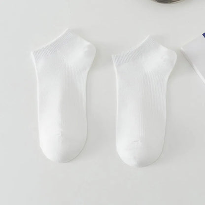 Pair of solid colour low-cut polyester boat socks for men, shown in one of six available colour options.
