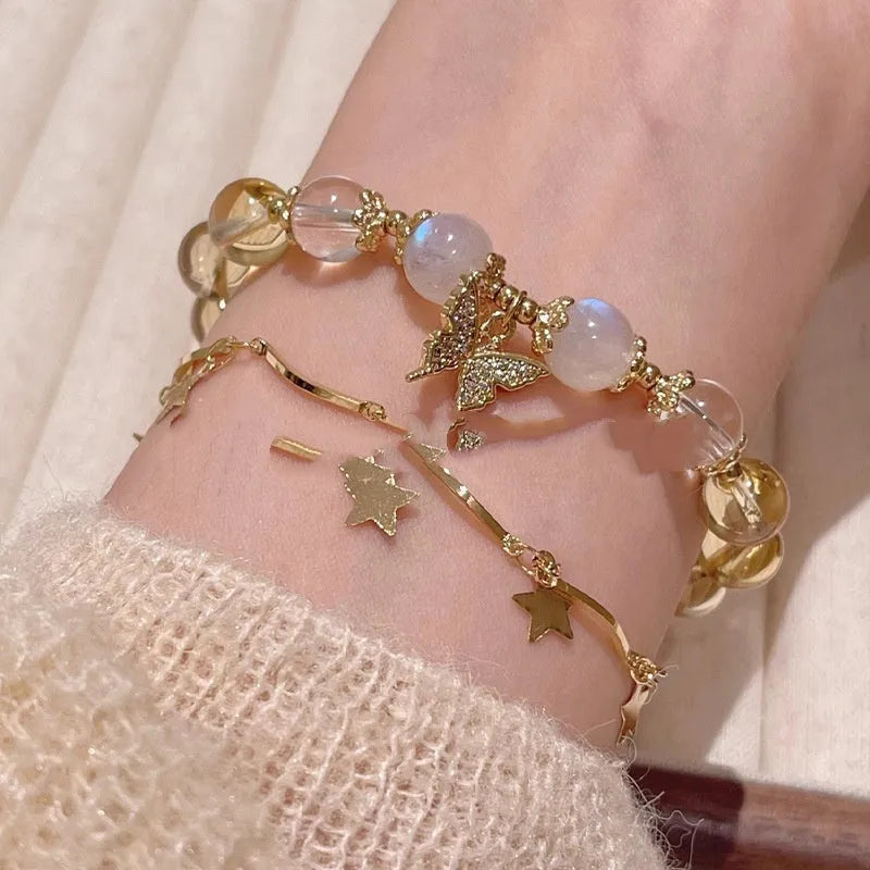 Chinese style white crystal beaded bracelet with citrine butterfly charm on adjustable string.