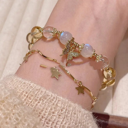 Chinese style white crystal beaded bracelet with citrine butterfly charm on adjustable string.