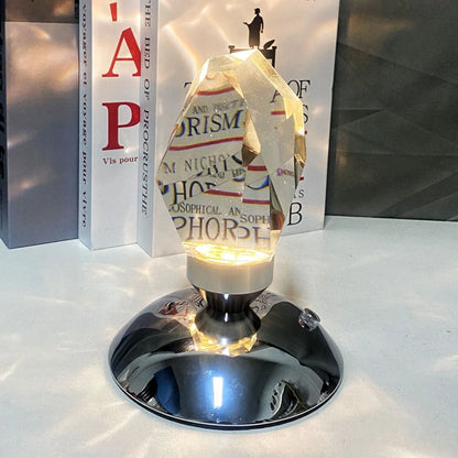 LED Crystal Night Light with remote control and 16 color options on a bedside table