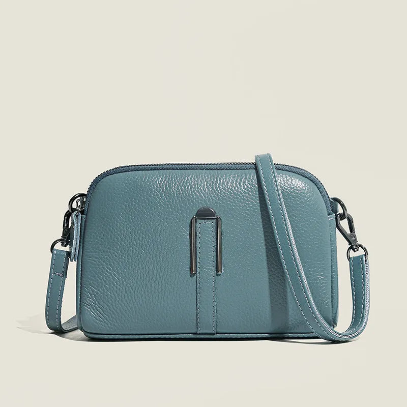 Women's genuine leather square shoulder bag in black, shown from front, displaying structured horizontal shape.