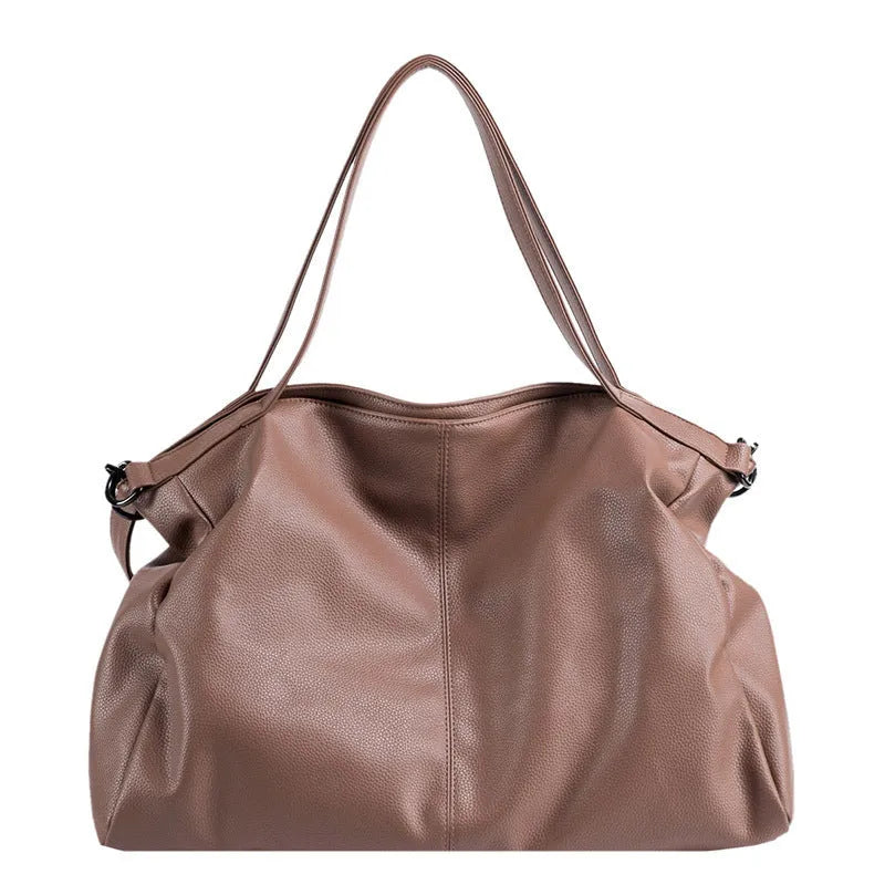 Large soft black PU messenger bag with long shoulder strap and front car suture detailing