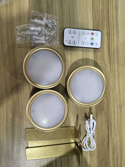 Black magnetic LED painting lamp with remote control on a white wall.