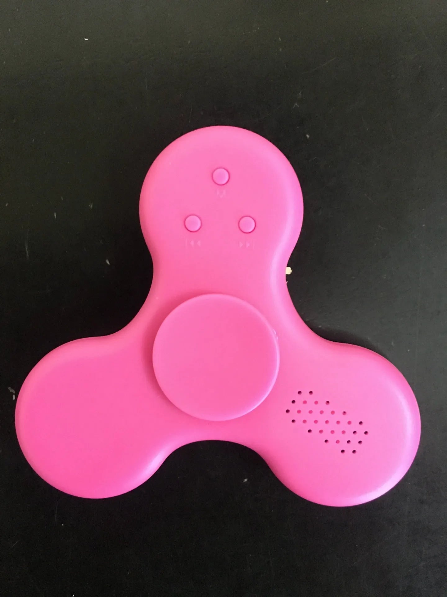White Bluetooth speaker fidget spinner EDC toy with MP3 player functionality showing compact design