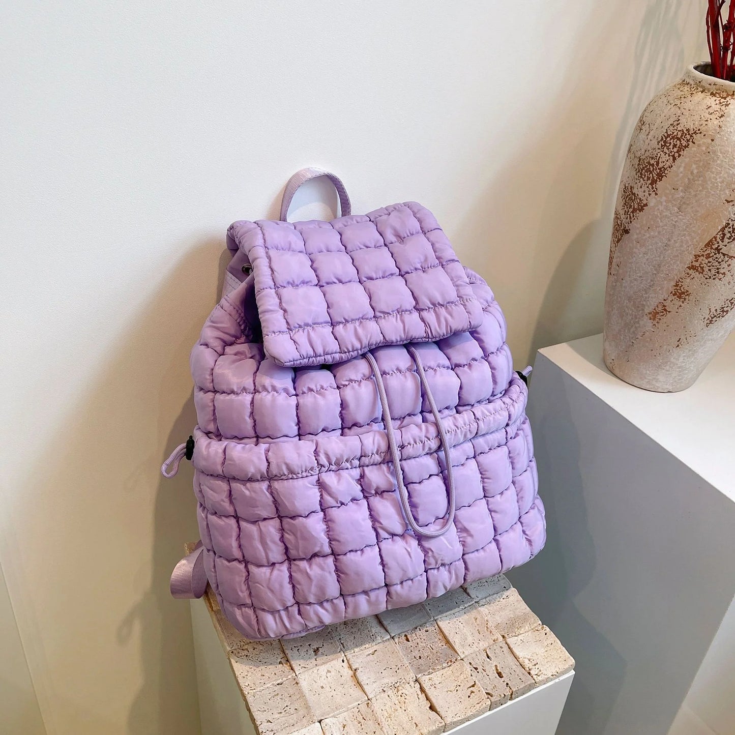 Soft, quilted puffer backpack in a variety of colors, perfect for autumn and winter wear