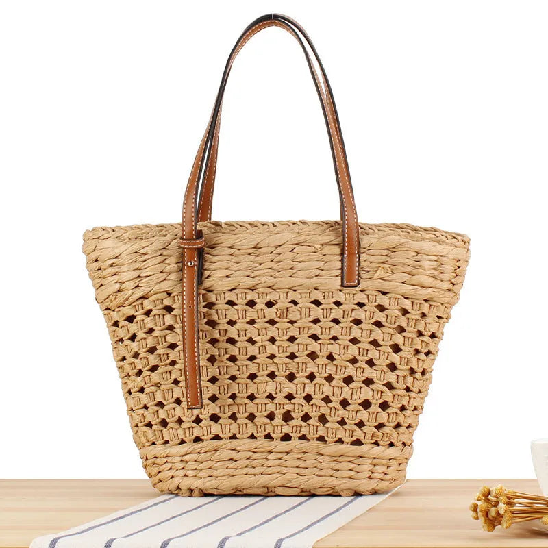 Beige woven paper-string shoulder bag with horizontal square shape and adjustable strap