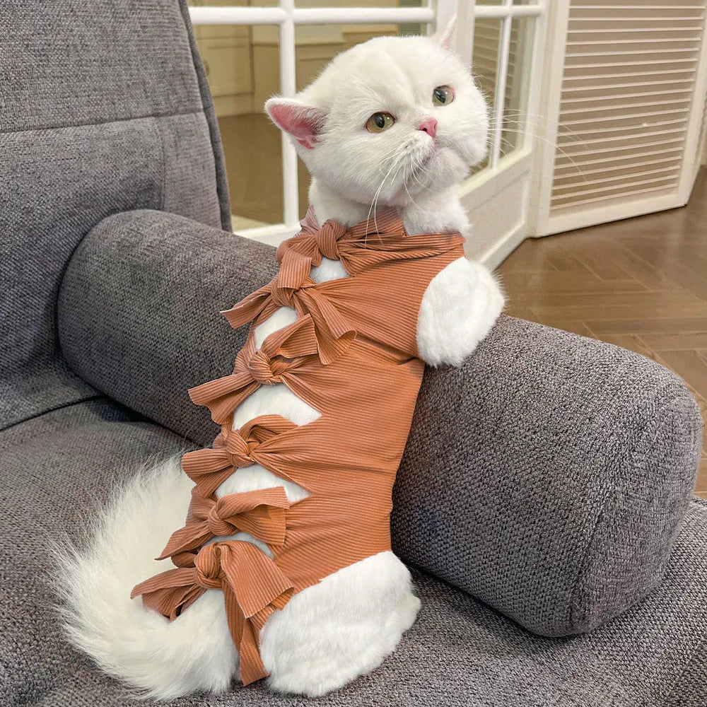 Lace-up cat sterilisation clothing in five colours including pink, purple, blue, brown, and green pineapple, showing adjustable fastening
