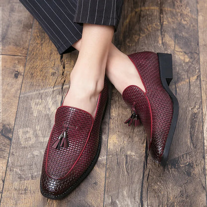 Men's black pointed toe slip on shoe with a decorative tassel on the artificial PU upper.