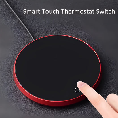 Black USB heating coaster on a desk next to a coffee mug, showing touch controls and coloured indicator light.