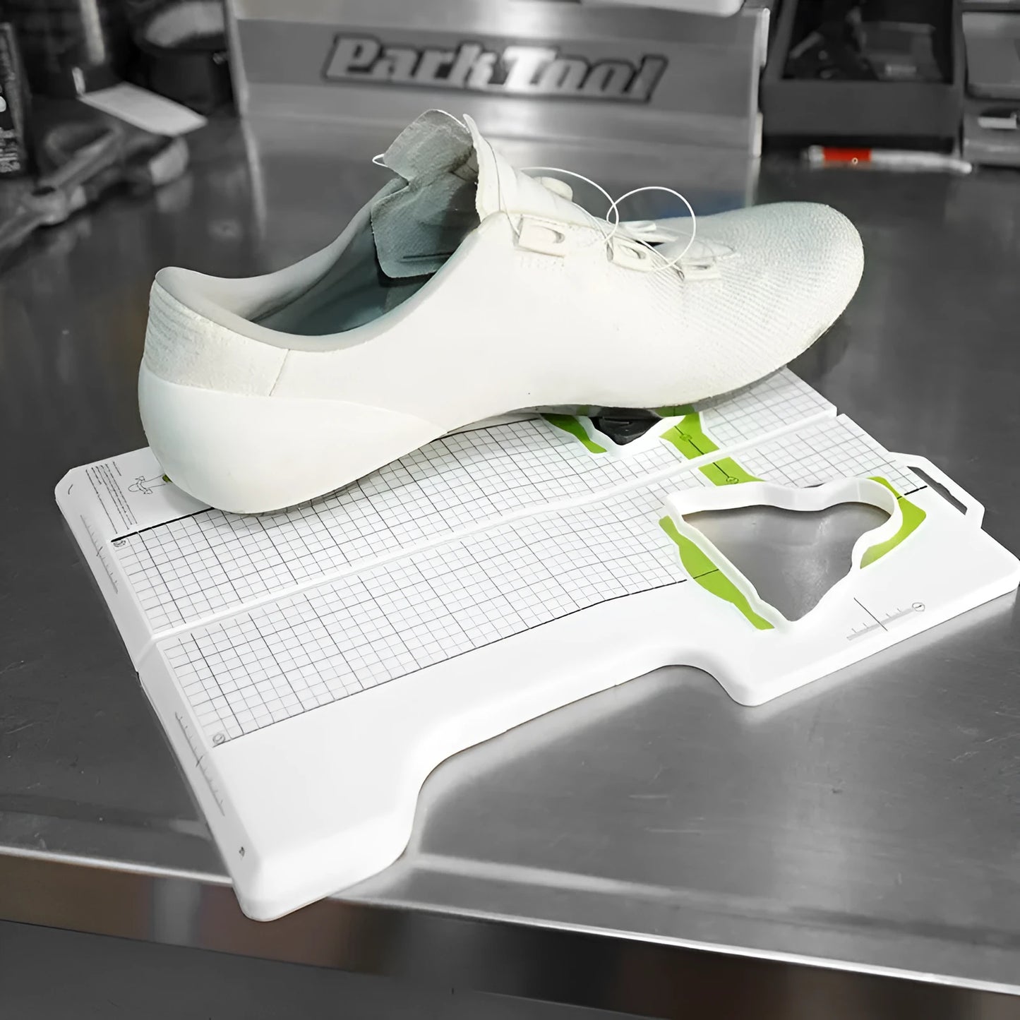 Locking plate adjustment tool for bicycle cleats on a workbench.