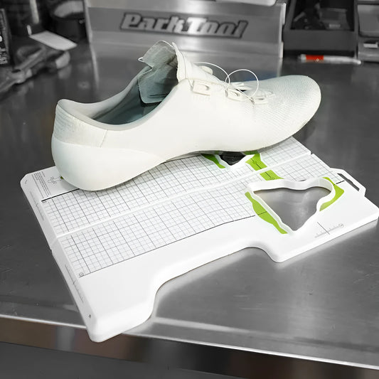 Locking plate adjustment tool for bicycle cleats on a workbench.