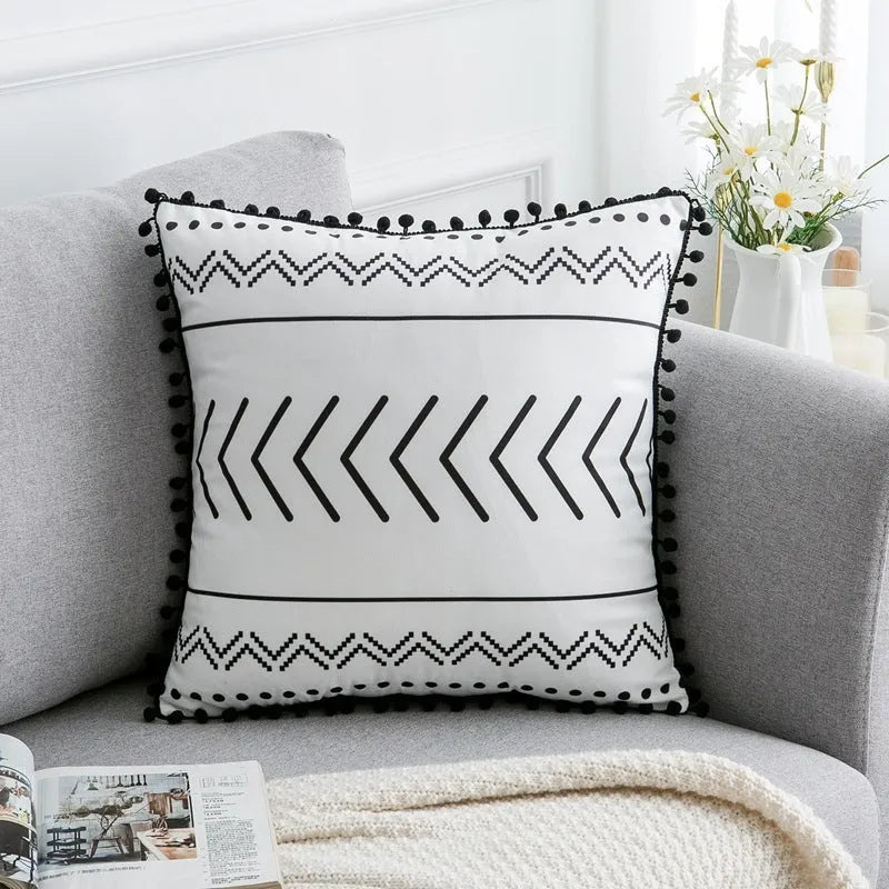 Bohemian style decorative pillowcase in light grey colour on a sofa.