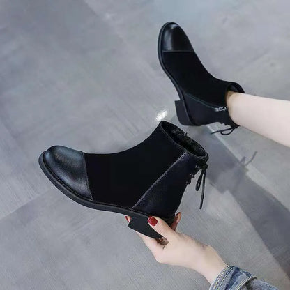 Women's black knee-length Martin boots with side zipper, non-slip rubber sole, and bow detail on microfiber upper