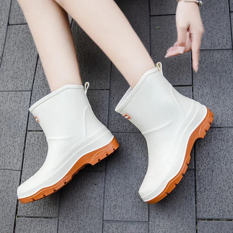 Women's low-cut white waterproof plastic shoes with a non-slip rubber sole on a plain background.