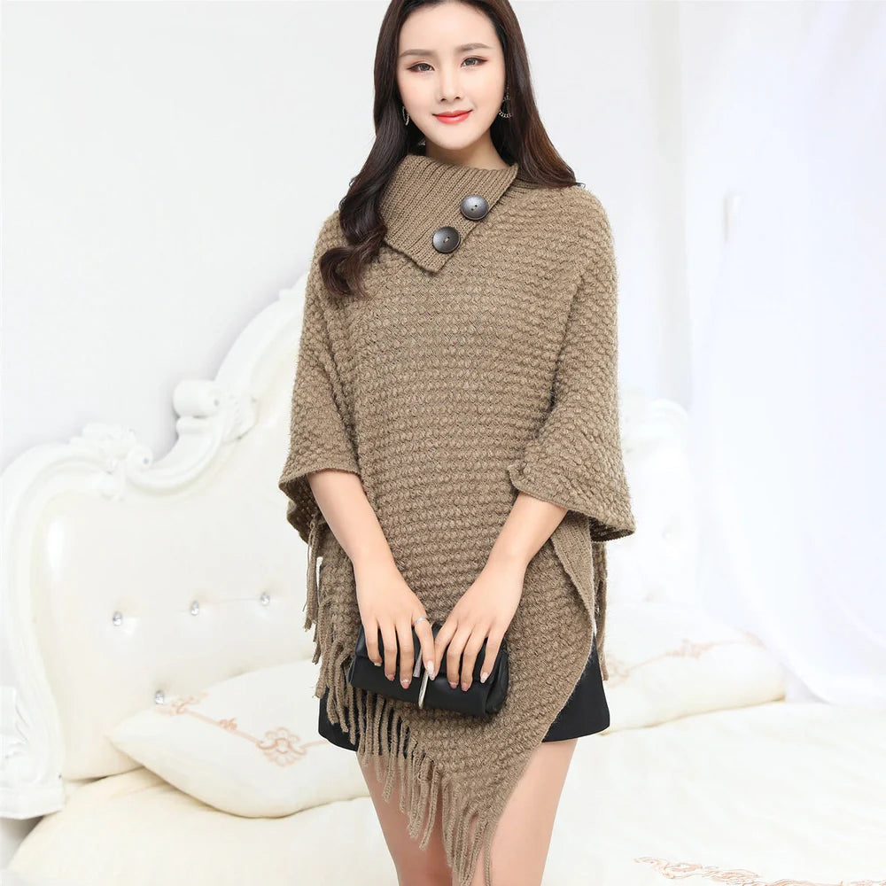 Sleeveless polka dot shawl in apricot colour draped over chair, showing 150cm length and acrylic fibre texture