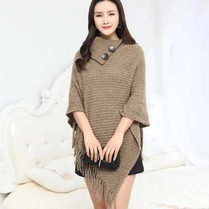 Sleeveless polka dot shawl in apricot colour draped over chair, showing 150cm length and acrylic fibre texture