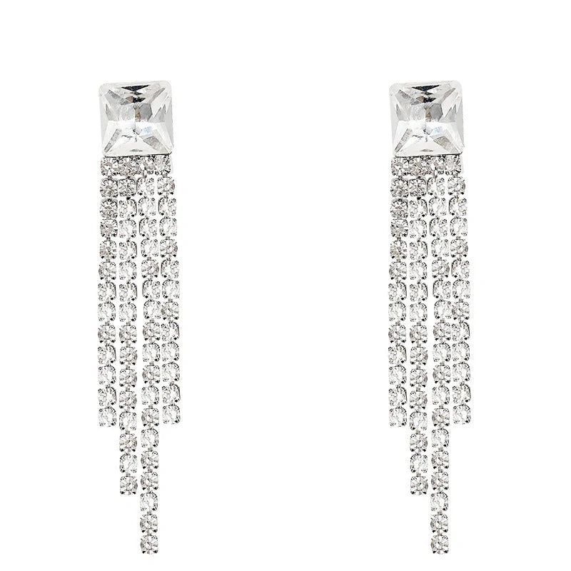 Sparkling zircon tassel earrings in sterling silver, featuring dazzling gems and flowing tassels for a bold, fashionable look.