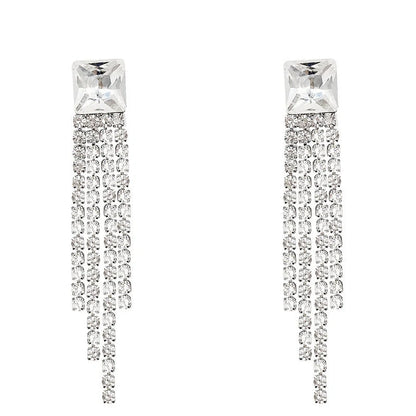 Sparkling zircon tassel earrings in sterling silver, featuring dazzling gems and flowing tassels for a bold, fashionable look.
