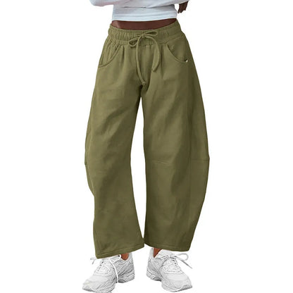 Loose fit cropped sweatpants in apricot colour with drawstring waist and side pockets on a neutral background.