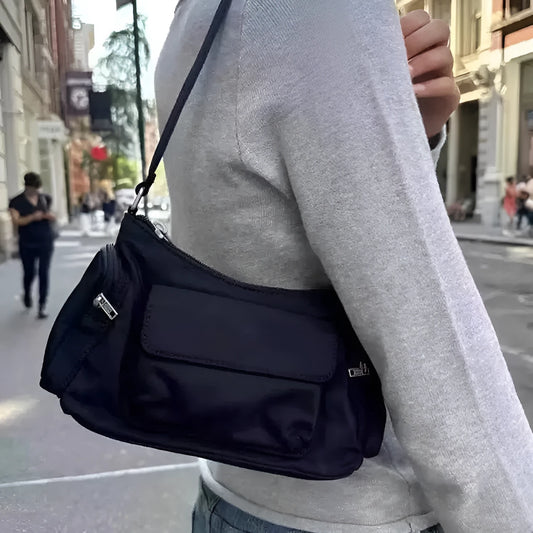 Black PU women's shoulder bag with two pockets and side line detailing, showing dimensions of 24cm length