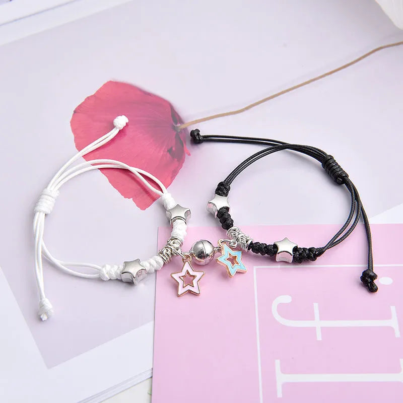 Magnetic suction couple bracelet pair in alloy with an electroplated finish, showing example designs like a crown and love lock.