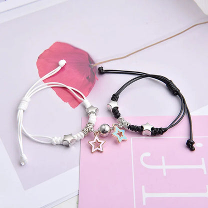 Magnetic suction couple bracelet pair in alloy with an electroplated finish, showing example designs like a crown and love lock.