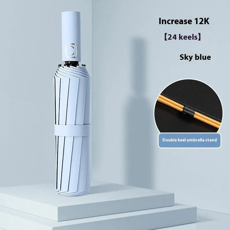 Large triple-folding manual umbrella open, showing its full canopy size and plastic handle.