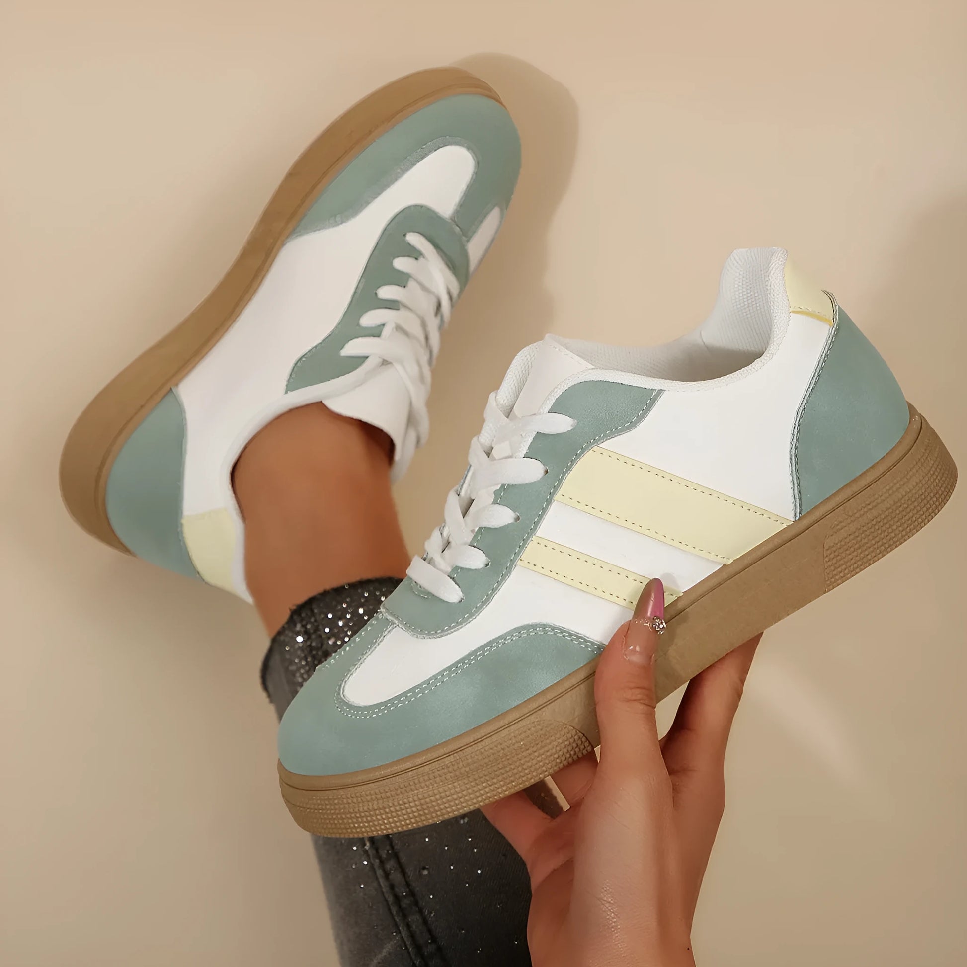 Green women's low-top retro sports shoes with cross-strap design and round toe.