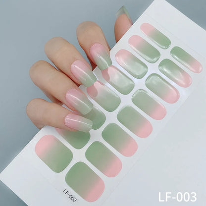 Sheet of 16 small design nail art stickers including cross, rose, tulip and marble patterns.