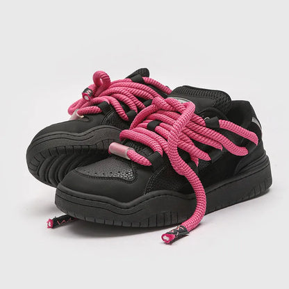 A pair of thick-soled casual lace-up shoes in a solid colour with a round toe and mesh lining.