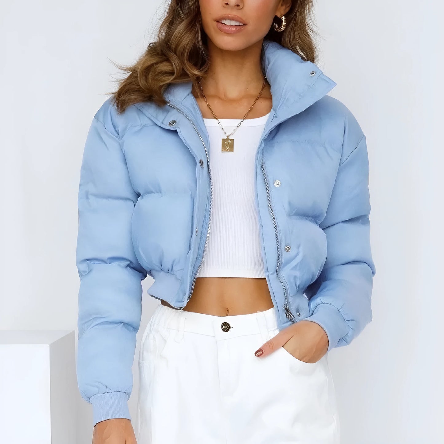 Women's loose-fit long sleeve polyester jacket in blue on a hanger.