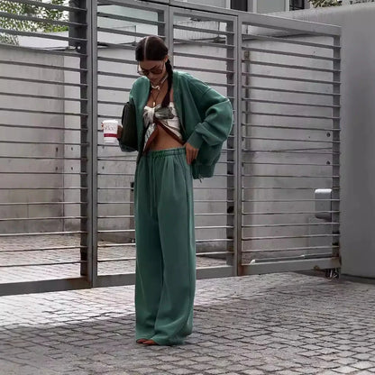 Green women's thermal sweater with front zipper and stand collar, paired with matching trousers