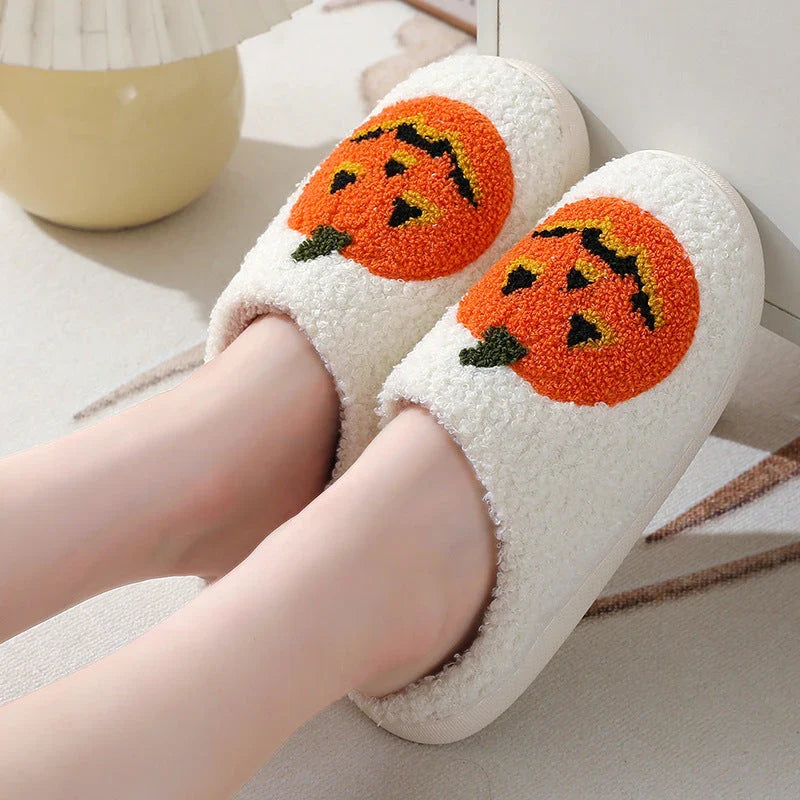 Pumpkin-shaped slippers in white and black colors, featuring a cozy cotton lining and non-slip rubber sole for comfortable indoor wear.