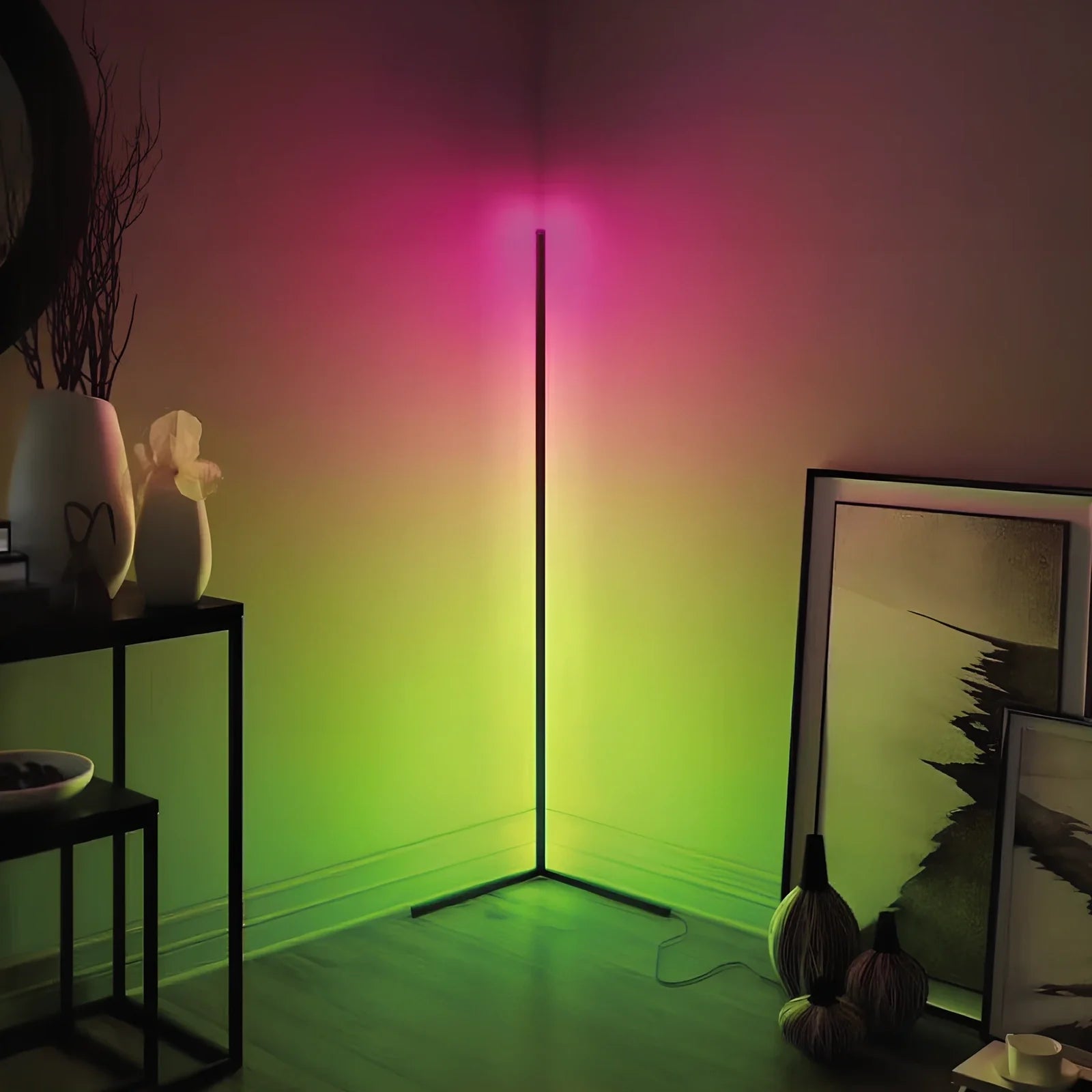 Black smart RGB floor lamp with remote control showing colour-changing illumination in bedroom setting