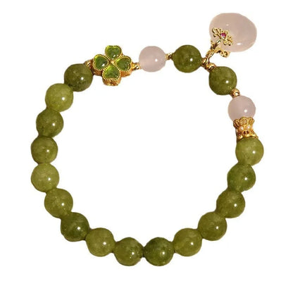 Green tourmaline women's bracelet with four-leaf clover safety buckle and geometric drop shape.