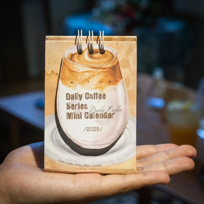 2025 mini desk calendar showing one of four designs: Coffee Time, Awake Time, Corner Perching, or Afternoon Lazy.