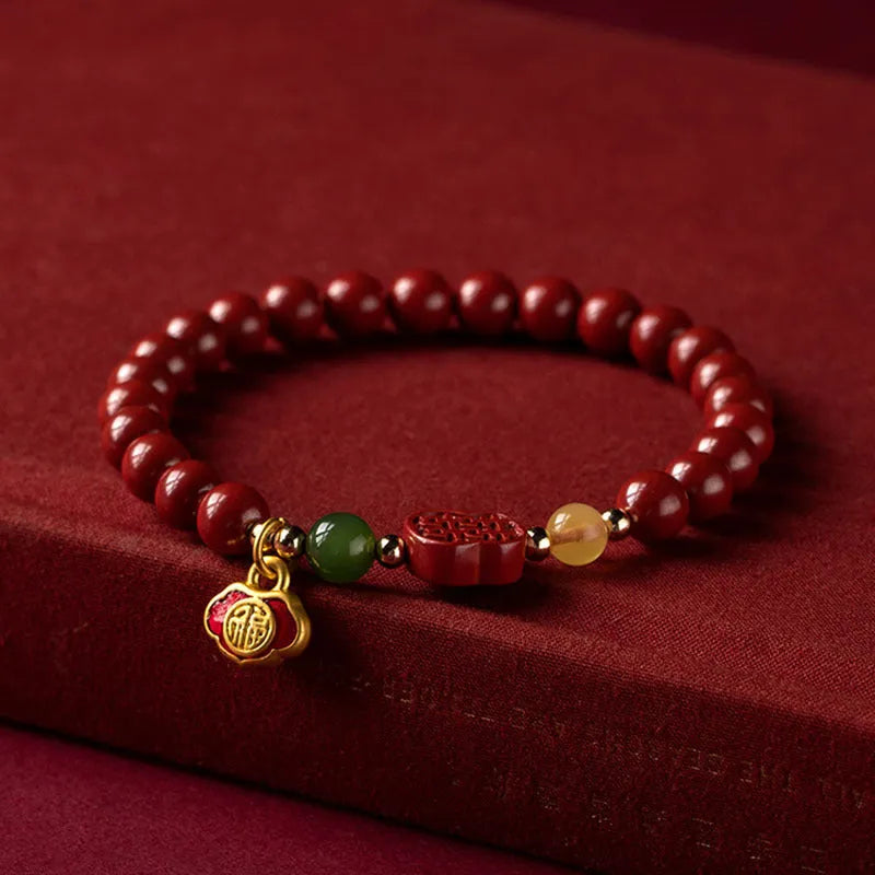 Emperor Sandstone bracelet with fu character, available in 6mm or 8mm cinnabar beads.