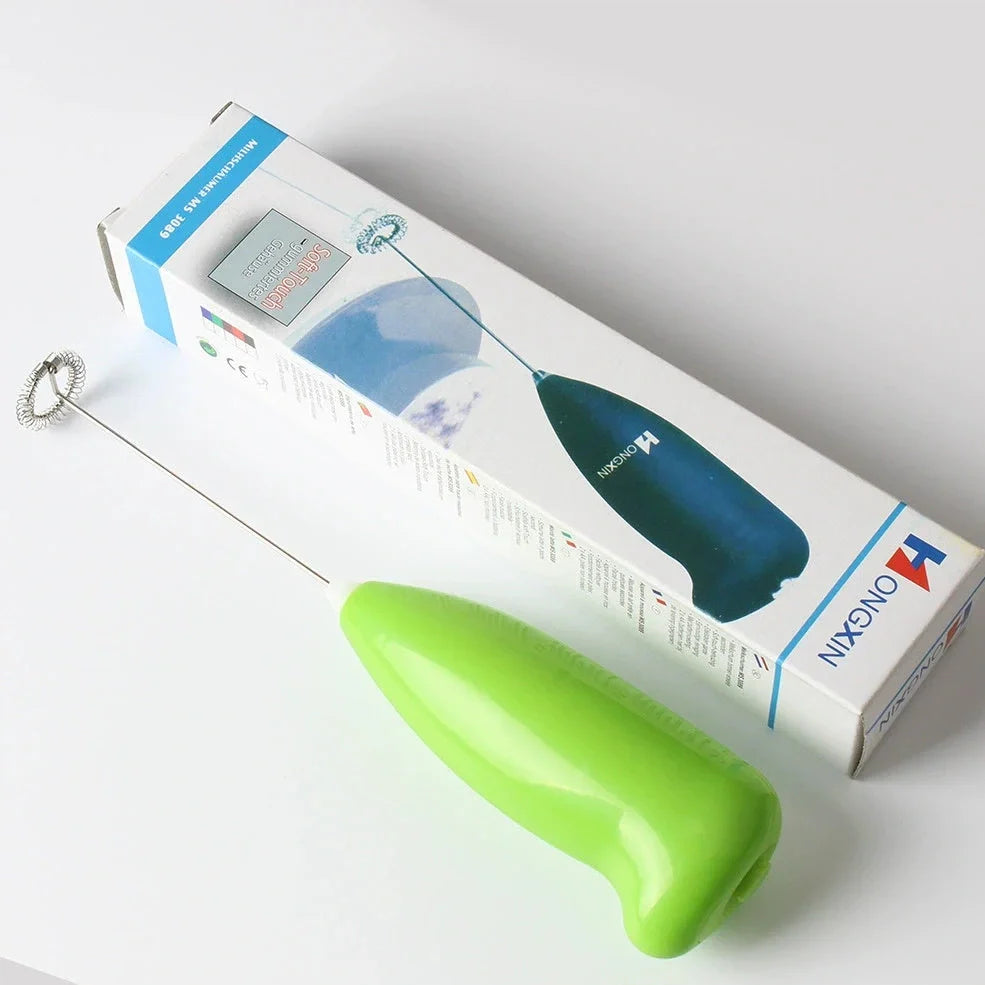 Green electric milk frother measuring 21cm tall with 5cm base creating milk foam
