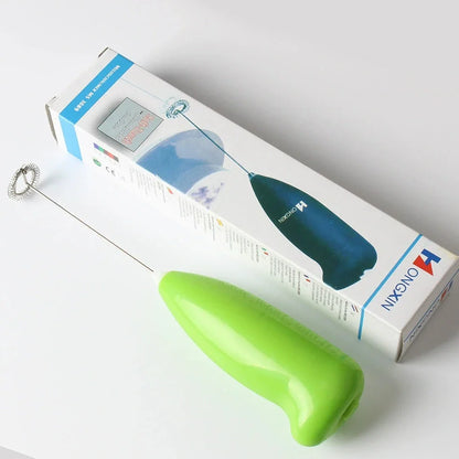Green electric milk frother measuring 21cm tall with 5cm base creating milk foam