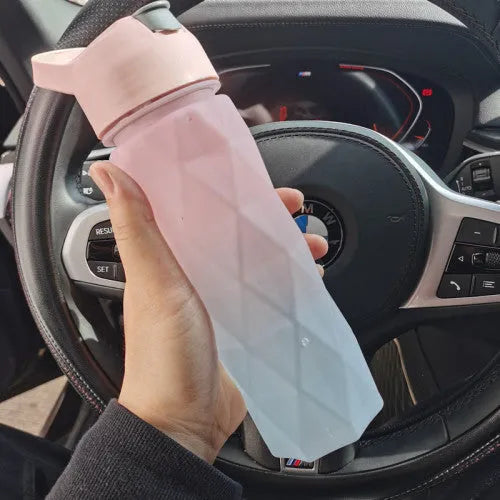 Large plastic spray water bottle with handle strap and leakproof lid in green colour.