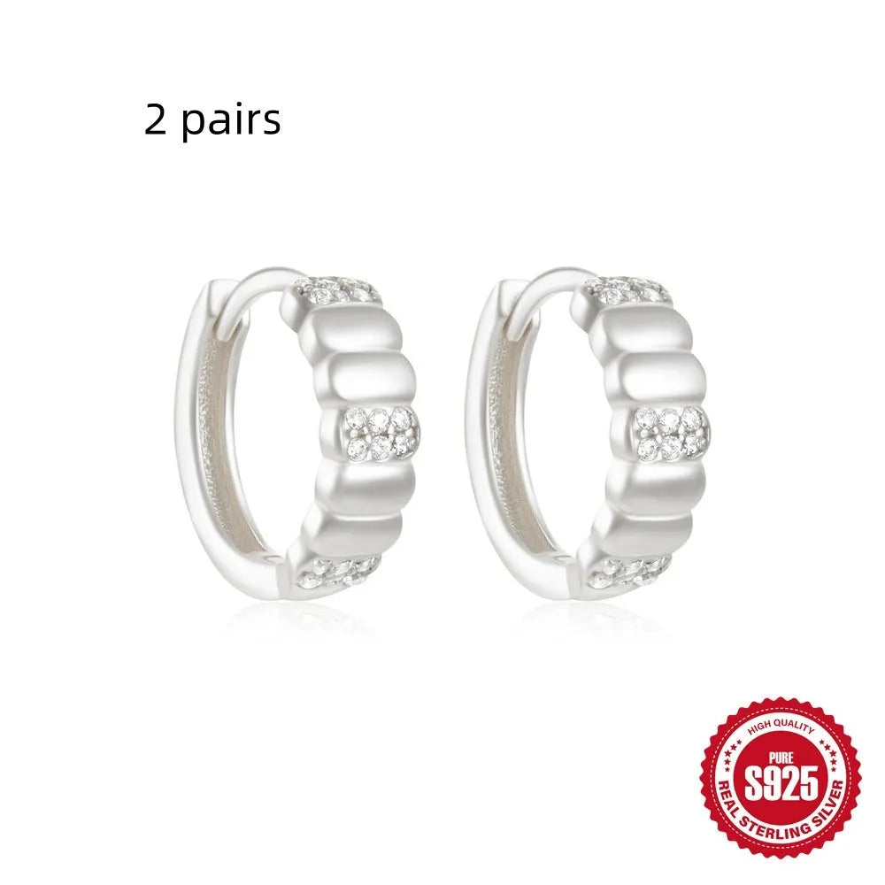 Sterling silver geometric stud earrings with small round diamond accents in gold or silver finish