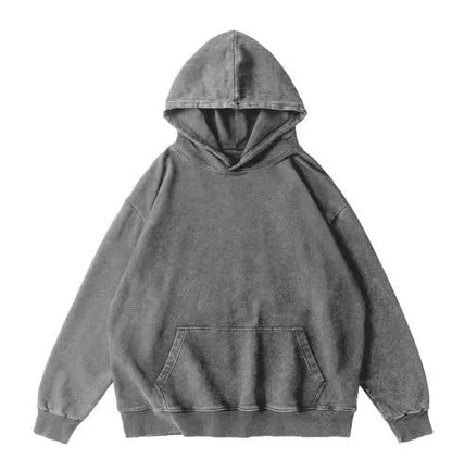 Man modelling a loose, brown batik-dyed cotton hoodie with a collarless neckline and drop-shoulder sleeves.