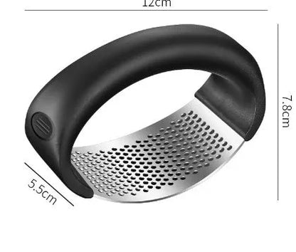 Stainless steel garlic press with ergonomic handle in kitchen setting