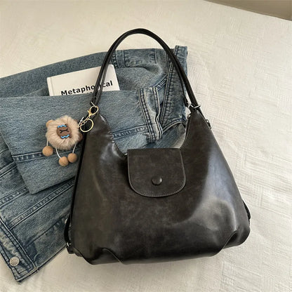 Textured PU leather women's shoulder bag in black with single strap and optional pendant