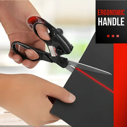 Black laser-guided scissors with red beam cutting straight line on wrapping paper