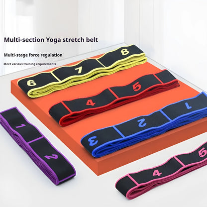 Blue multi-section yoga stretch strap for Pilates and dance exercises on a wooden floor