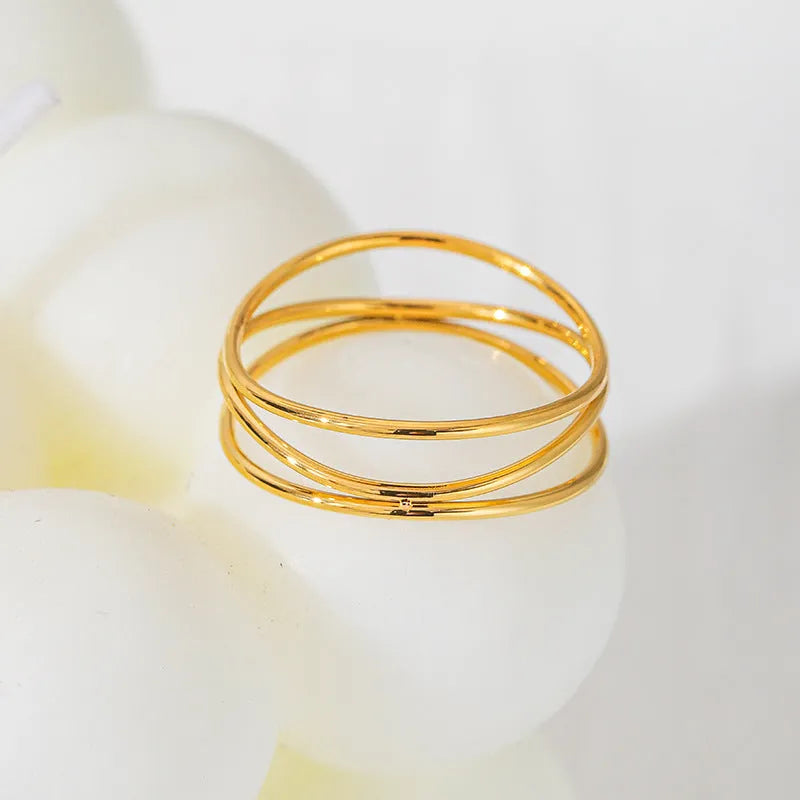 Geometric line ring with three-layer gold coil design on titanium steel band